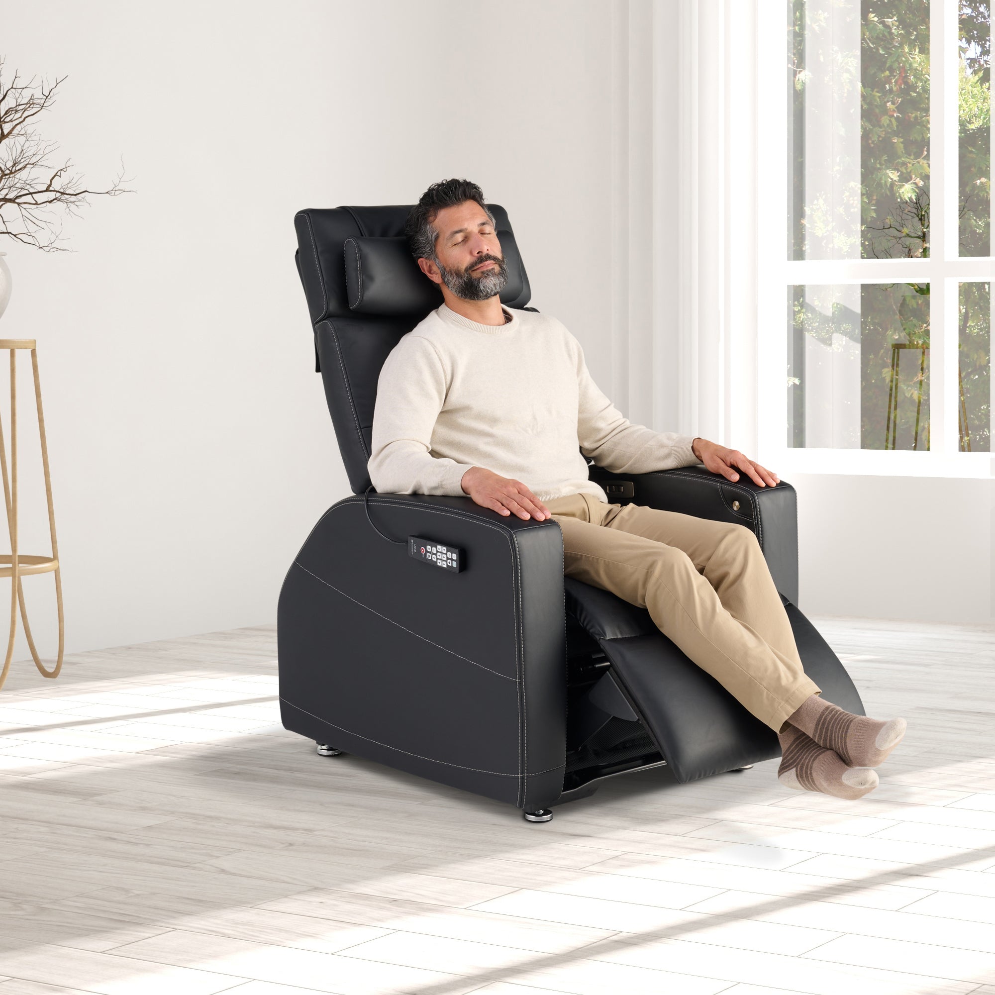 Laevo ZG Chair with Lift Assist shown in black leather, featuring reclining position with massage and heat functions