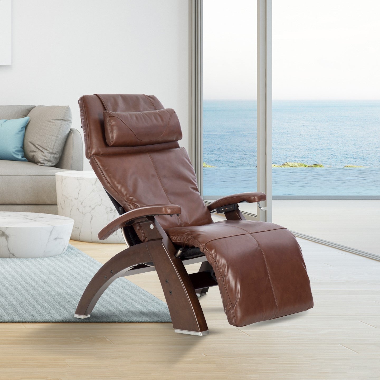 Perfect Chair PC-420 Classic Manual Plus recliner in brown leather with curved wooden base, shown in oceanview setting