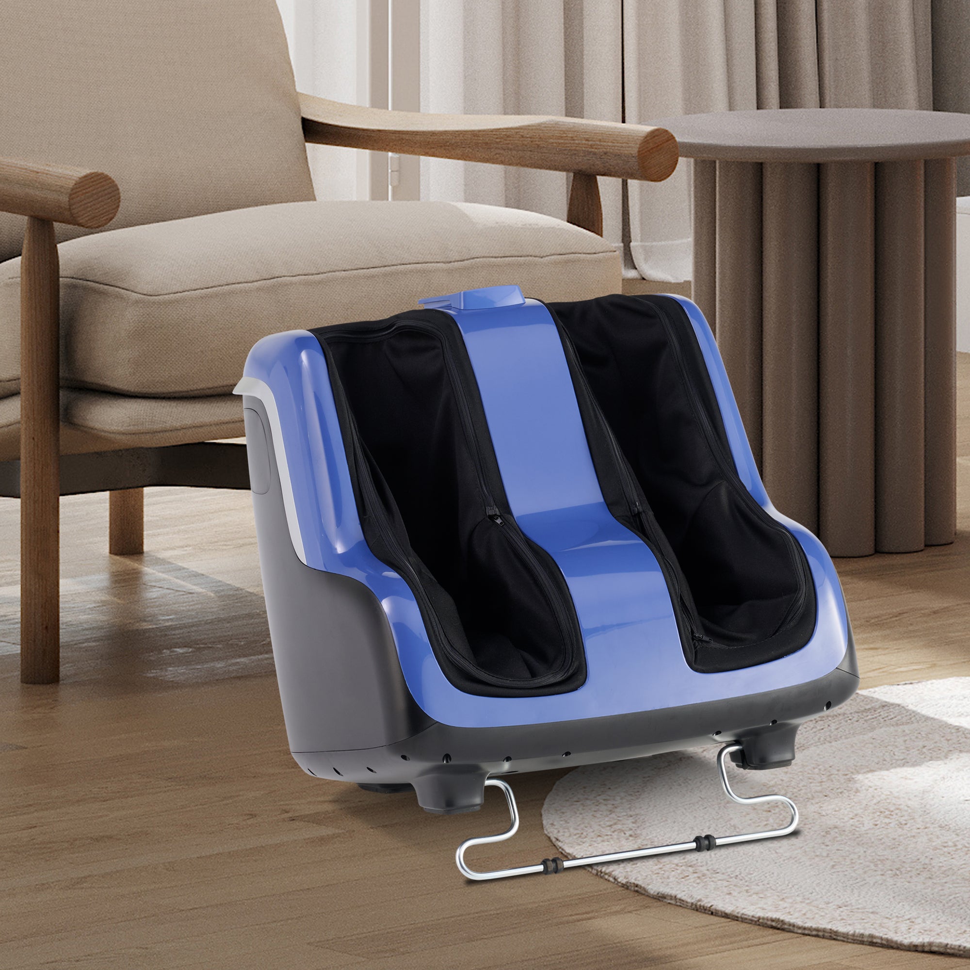 Reflex SOL Plus foot and calf massager with blue accents shown on hardwood floor next to beige armchair