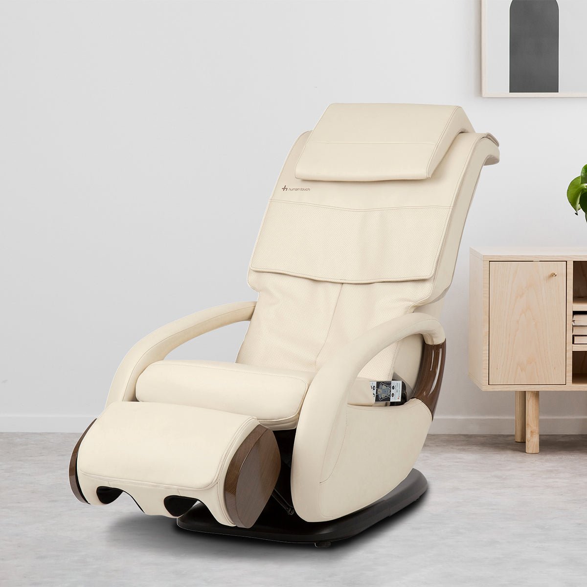 WholeBody 8.0 Massage Chair in cream leather, modern design with curved armrests and adjustable footrest in minimalist room