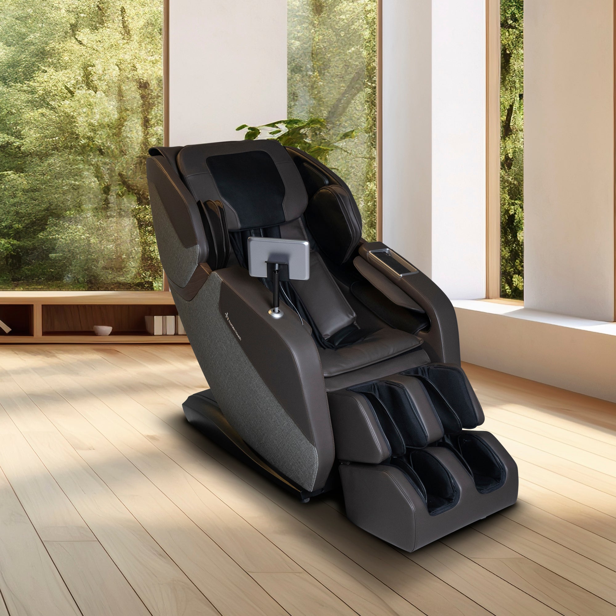 WholeBody ROVE massage chair in modern black, positioned in bright room with large windows and natural scenery