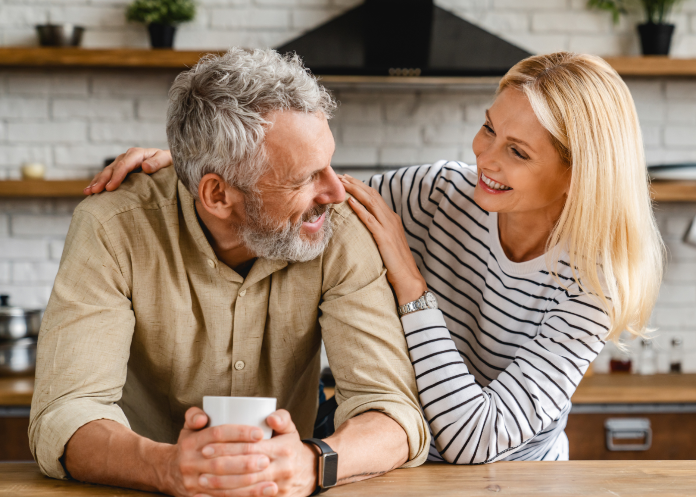 Man and woman in kitchen smiling